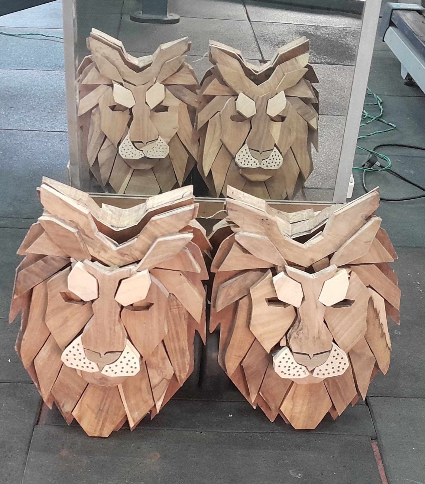 Finished wooden lion faces in warm polished wood